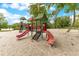 A charming neighborhood playground with colorful slides and climbing structures, surrounded by soft sand at 419 Sheoah Blvd # 27, Winter Springs, FL 32708