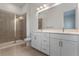 Bathroom with double vanity, frameless shower, and tiled floor at 42 W Harding St # E, Orlando, FL 32806