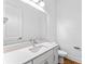 Bathroom featuring a vanity with a mirror, a toilet, light fixtures, and modern cabinetry with beautiful floors at 42 W Harding St # E, Orlando, FL 32806