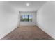 Bedroom with large window, neutral carpet and lots of natural light at 42 W Harding St # E, Orlando, FL 32806
