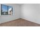 A cozy bedroom features a large window with blinds and neutral carpet at 42 W Harding St # E, Orlando, FL 32806