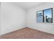 Bright bedroom features a large window offering natural light and neutral carpet at 42 W Harding St # E, Orlando, FL 32806