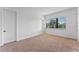 Bedroom features neutral carpet, a window and two doors at 42 W Harding St # E, Orlando, FL 32806