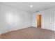 Bedroom with neutral carpet features two doors and a view into another room at 42 W Harding St # E, Orlando, FL 32806