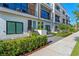 Exterior view of the townhome with lush landscaping, a small yard, and a private entrance at 42 W Harding St # E, Orlando, FL 32806