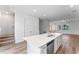 An island sink, stainless steel dishwasher, and views of stairs and living space, promoting an open concept at 42 W Harding St # E, Orlando, FL 32806
