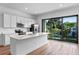 Sleek kitchen with stainless appliances, white cabinets, and a large island, perfect for entertaining at 42 W Harding St # E, Orlando, FL 32806