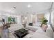 Spacious living room with modern sofas, decor, wood flooring, with an open view of the modern kitchen at 42 W Harding St # E, Orlando, FL 32806