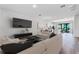 Living room with an open floor plan, a comfortable seating area, and views into the modern kitchen at 42 W Harding St # E, Orlando, FL 32806