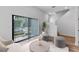 Bright living room with neutral décor, large windows, and stylish modern flooring at 42 W Harding St # E, Orlando, FL 32806