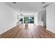 A spacious open-concept living area with lots of natural light and wood flooring extending to the modern kitchen at 42 W Harding St # E, Orlando, FL 32806