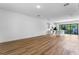 A spacious open-concept living area with lots of natural light and wood flooring extending to the modern kitchen at 42 W Harding St # E, Orlando, FL 32806