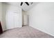 A spacious bedroom with neutral carpeting and a double door closet for ample storage at 426 Citrus Isle Loop, Davenport, FL 33837