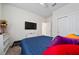 A cozy bedroom featuring neutral carpeting and a bed with multiple colorful pillows at 426 Citrus Isle Loop, Davenport, FL 33837