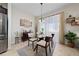 Cozy dining room with a round glass table and natural light, perfect for Gathering meals at 426 Citrus Isle Loop, Davenport, FL 33837
