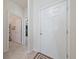 Bright foyer features neutral tile flooring, a white front door, and access to other rooms in the home at 426 Citrus Isle Loop, Davenport, FL 33837