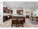 Open kitchen with wood cabinets, central island with seating, stainless appliances, and adjacent breakfast nook at 426 Citrus Isle Loop, Davenport, FL 33837