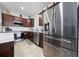 Kitchen with stainless steel appliances, wood cabinets, tile floors and white countertops at 426 Citrus Isle Loop, Davenport, FL 33837
