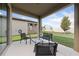 Covered patio with outdoor seating and a view of the fenced backyard at 426 Citrus Isle Loop, Davenport, FL 33837