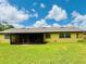 Spacious backyard with a screened-in porch, perfect for outdoor relaxation and entertaining at 4640 Chateau Rd, Orlando, FL 32808