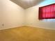 Bedroom with neutral carpet, white walls, and a large window with red drapes at 4640 Chateau Rd, Orlando, FL 32808