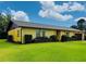 Side view of a one story home with a beautiful lawn and well maintained shrubbery at 4640 Chateau Rd, Orlando, FL 32808