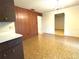 View of the kitchen cabinets and dining area that features wood paneling at 4640 Chateau Rd, Orlando, FL 32808