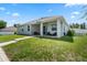Covered back porch with neutral finishes, comfortable seating, and a paved walkway at 4811 Sw 108Th Place Rd, Ocala, FL 34476