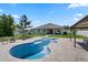 Spacious backyard featuring a pool, lush lawn, and a covered patio for outdoor entertaining at 4811 Sw 108Th Place Rd, Ocala, FL 34476