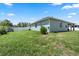Expansive backyard with lush green lawn, fenced perimeter, and a useful storage shed at 4811 Sw 108Th Place Rd, Ocala, FL 34476