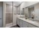 Bathroom features vanity with double sinks, granite countertops and walk in shower at 4811 Sw 108Th Place Rd, Ocala, FL 34476