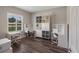 Bright bedroom features three work stations, built-in shelving, and hardwood floors at 4811 Sw 108Th Place Rd, Ocala, FL 34476