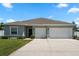 Charming single-story home with a two-car garage, neutral paint, and landscaped yard at 4811 Sw 108Th Place Rd, Ocala, FL 34476