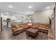 Spacious living area featuring wood-look floors and an over-sized sectional couch at 4811 Sw 108Th Place Rd, Ocala, FL 34476