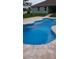 Backyard view of a private pool area featuring a stone surround, perfect for outdoor enjoyment at 4811 Sw 108Th Place Rd, Ocala, FL 34476