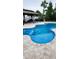 Inviting outdoor space featuring a gorgeous blue pool with a spa and poolside seating area at 4811 Sw 108Th Place Rd, Ocala, FL 34476