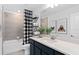 Modern bathroom with a shower/tub combination and a navy blue vanity with white countertop at 5033 Starling Bird Ln, St Cloud, FL 34771