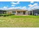 Wide backyard showcasing an outdoor patio, and lush lawn at 5215 Nw 34Th St, Ocala, FL 34482