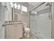 Bathroom featuring granite countertop vanity and modern shower with glass door and decorative tile accent at 5215 Nw 34Th St, Ocala, FL 34482