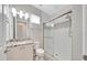 Bathroom featuring granite countertop vanity and modern shower with glass door and decorative tile accent at 5215 Nw 34Th St, Ocala, FL 34482