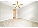 An empty bedroom with a ceiling fan, light grey floors, and plain white walls at 5215 Nw 34Th St, Ocala, FL 34482