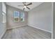Bright bedroom with wood-look tile flooring and natural light from windows at 5215 Nw 34Th St, Ocala, FL 34482