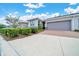 Well-maintained home exterior showcasing a two-car garage, landscaped yard, and inviting curb appeal at 5215 Nw 34Th St, Ocala, FL 34482