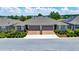 Aerial view of the charming home featuring a two-car garage and beautifully landscaped yard at 5215 Nw 34Th St, Ocala, FL 34482