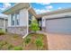 Charming single-Gathering home with stone accents, gray garage door and paved driveway at 5215 Nw 34Th St, Ocala, FL 34482