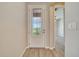 Elegant front door with decorative glass panel, opening to a light-filled foyer with gray flooring at 5215 Nw 34Th St, Ocala, FL 34482