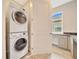Modern laundry area with stacked washer and dryer, counter space and cabinets for storage at 5215 Nw 34Th St, Ocala, FL 34482
