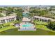 Aerial view of the community pool, tennis courts, and clubhouse, surrounded by mature trees and landscaping at 6 Escondido Cir # 55, Altamonte Springs, FL 32701