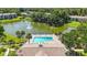 Aerial shot of the community pool, clubhouse, and lake, surrounded by trees and residential buildings at 6 Escondido Cir # 55, Altamonte Springs, FL 32701