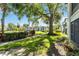 Well-maintained backyard featuring manicured hedges, mature shade trees, and building in the background at 6 Escondido Cir # 55, Altamonte Springs, FL 32701